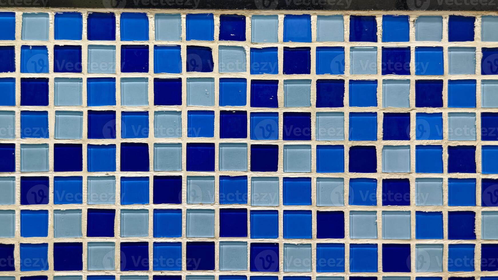 Vibrant Blue and Light Blue Mosaic Wall with Geometric Tile Design photo