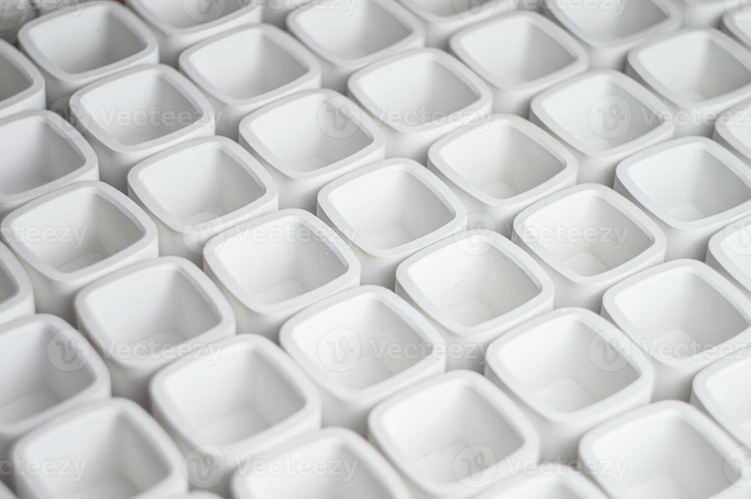 white plaster vessels blanks for candlesticks. rectangular cups cast from plaster in a candle workshop. High quality photo