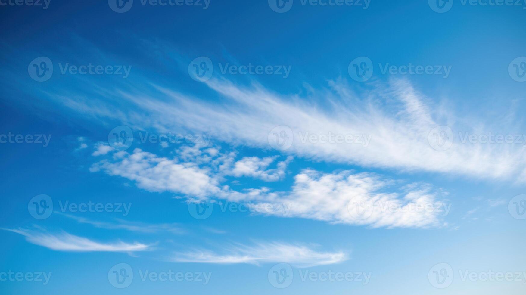 Cirrus Clouds High Above Forming Streaks Against Blue Canvas. Daydreaming in the heavens. photo