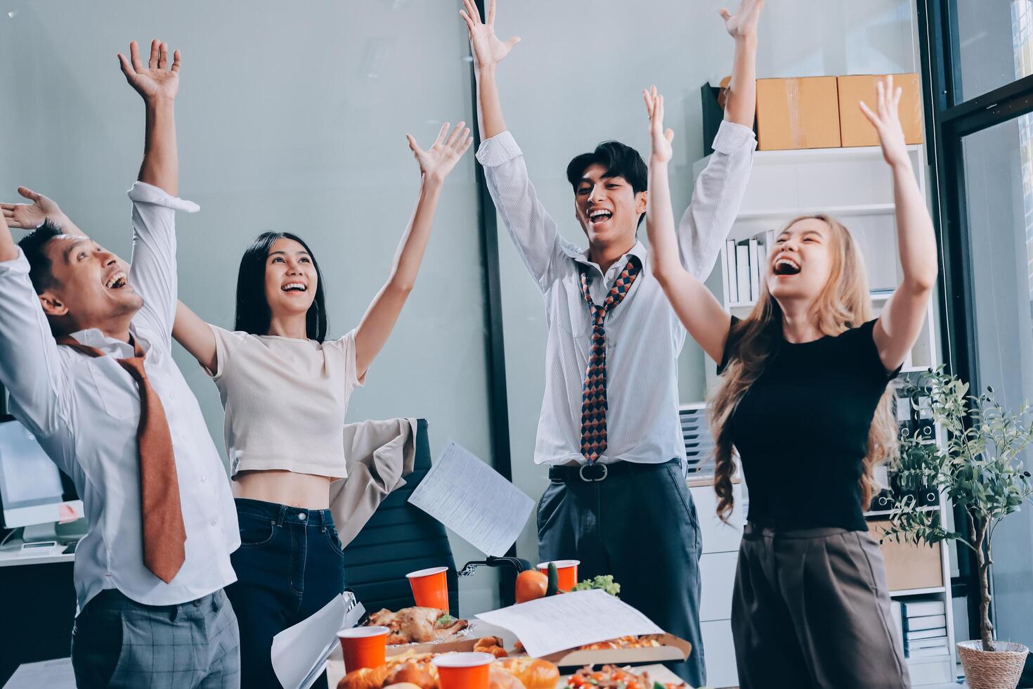 Group of young business people celebrating at the office photo