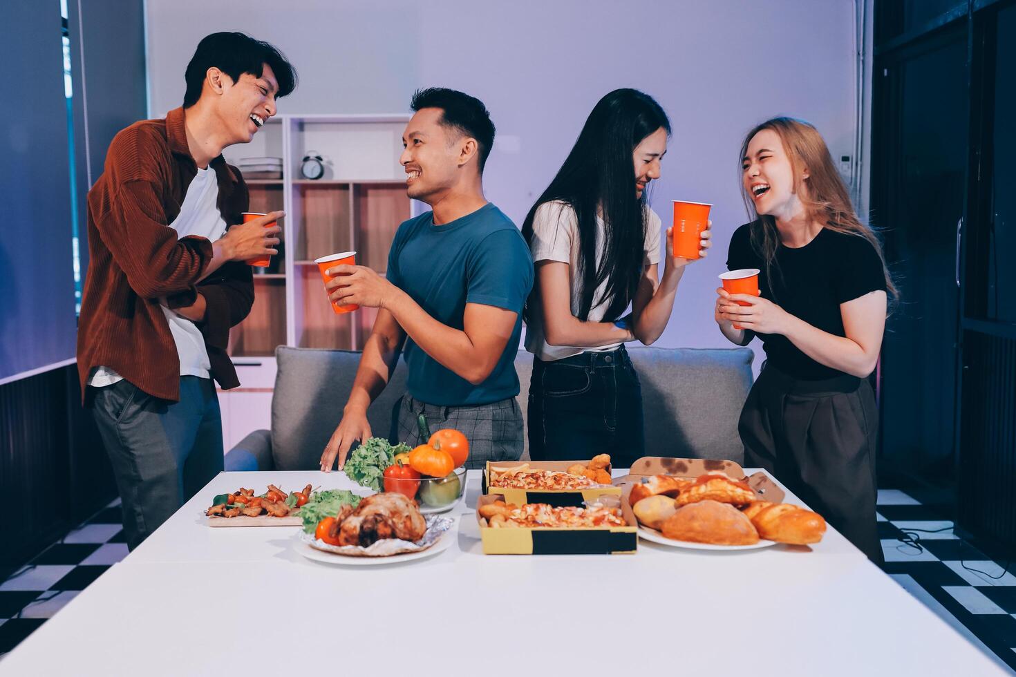 Four friends having a meal together with food photo