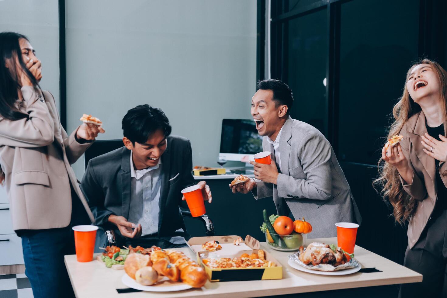 Group of people eating pizza and drinking beer photo