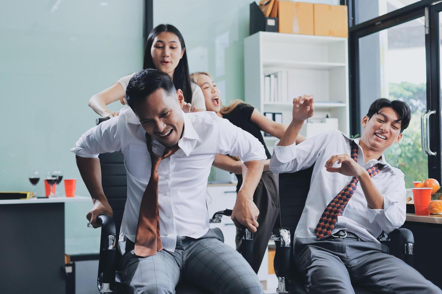 Three people in business attire are having fun in an office photo