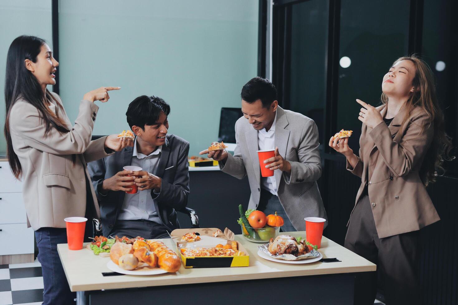 Group of business people eating food at table photo