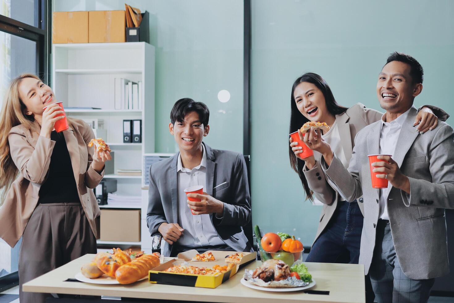 Group of asian business people eating food and drinking coffee photo