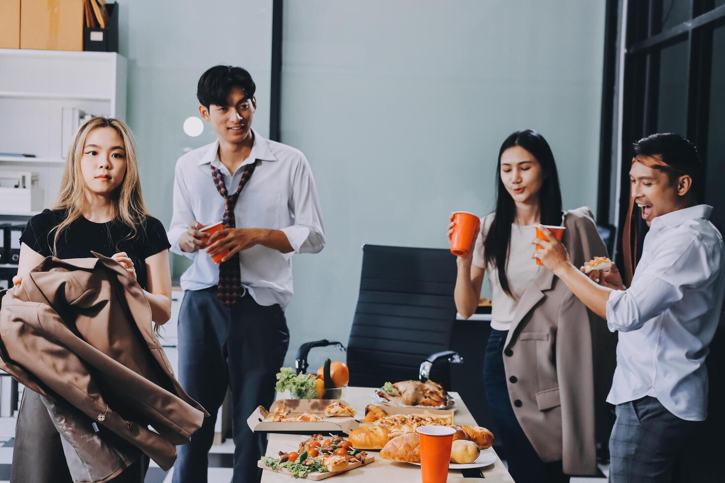 Group of business people eating lunch at table photo