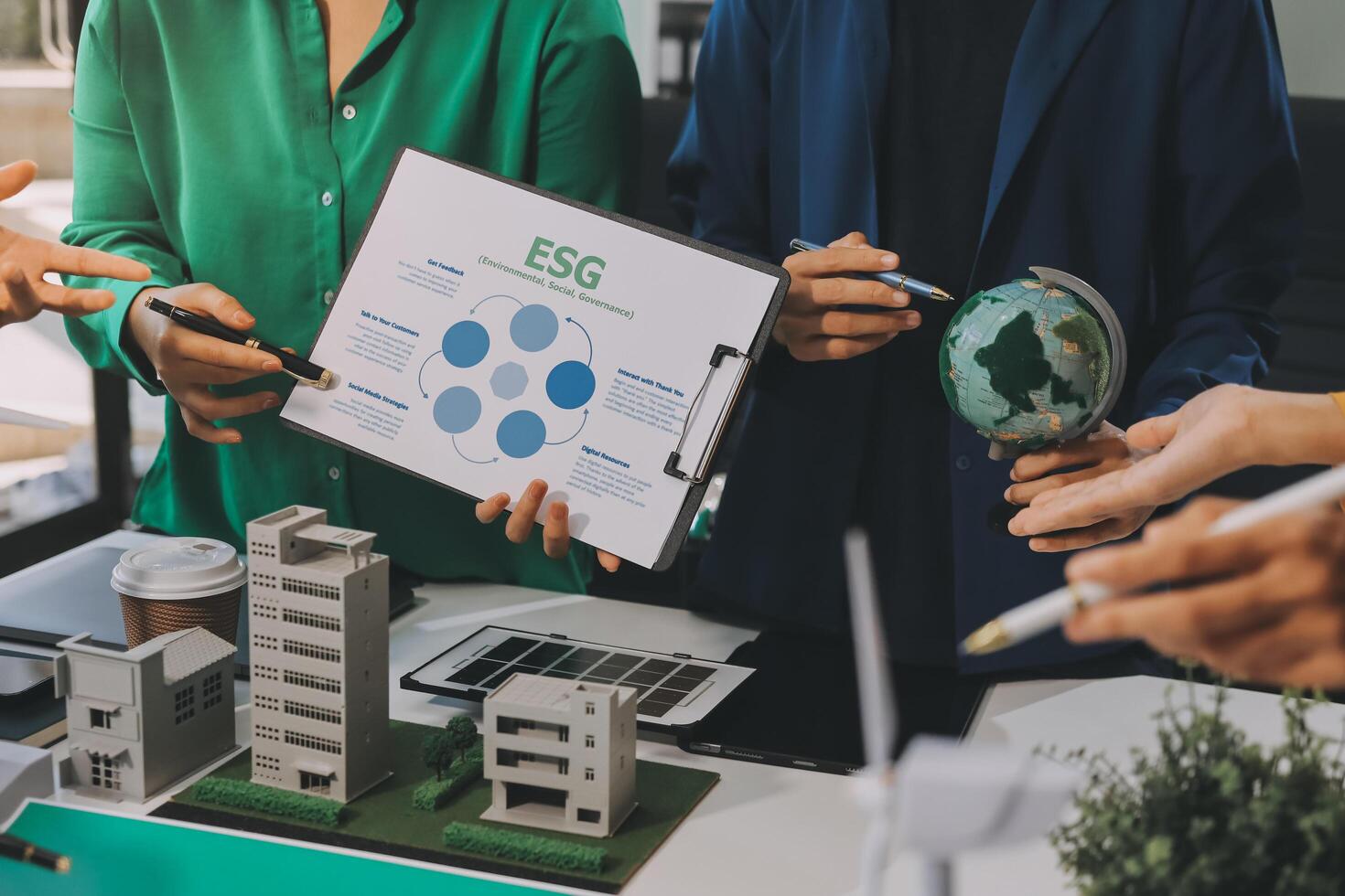 Business people working together on a project with a business plan photo