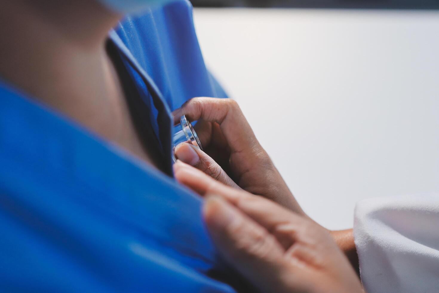 A nurse is putting on a blue shirt photo