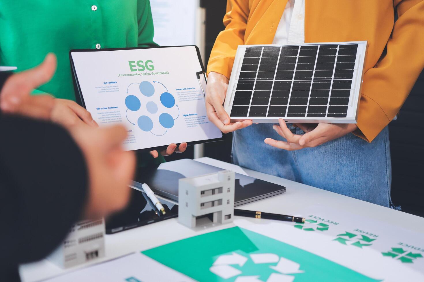 Business people holding a solar panel and a tablet photo