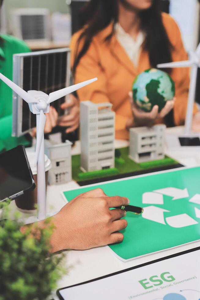 People working on a project with a green recycling sign photo