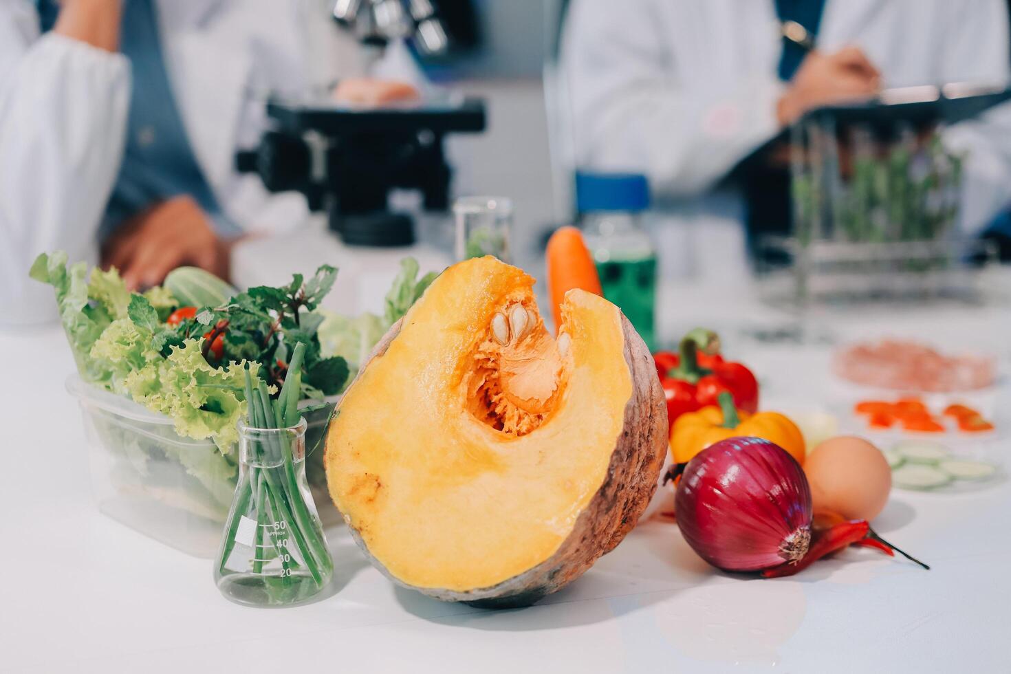 A scientist is holding a pumpkin and other vegetables photo