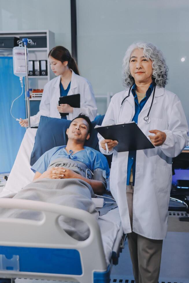 A doctor standing next to a patient in a hospital bed photo