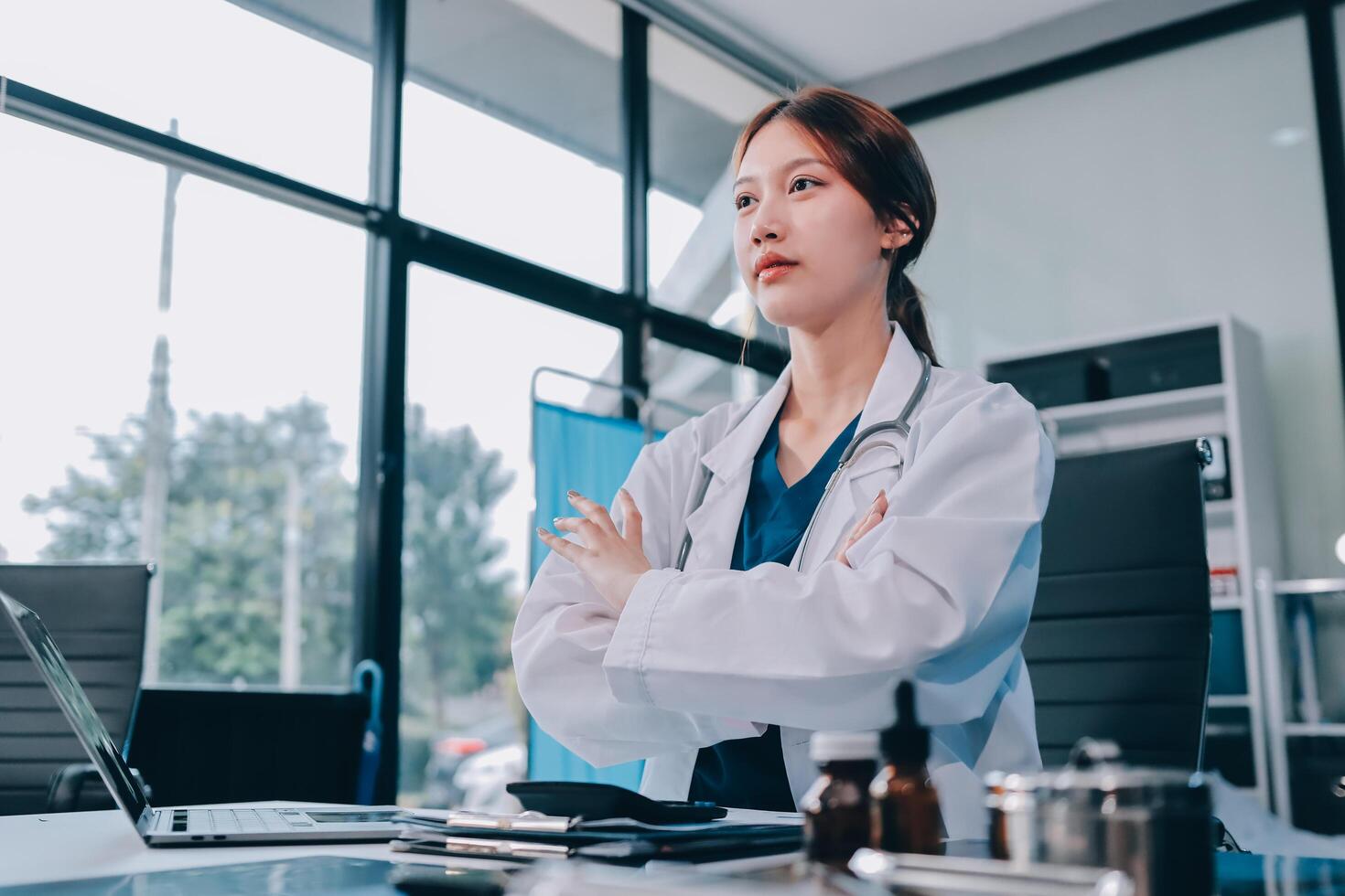 A female doctor standing in front of a desk photo