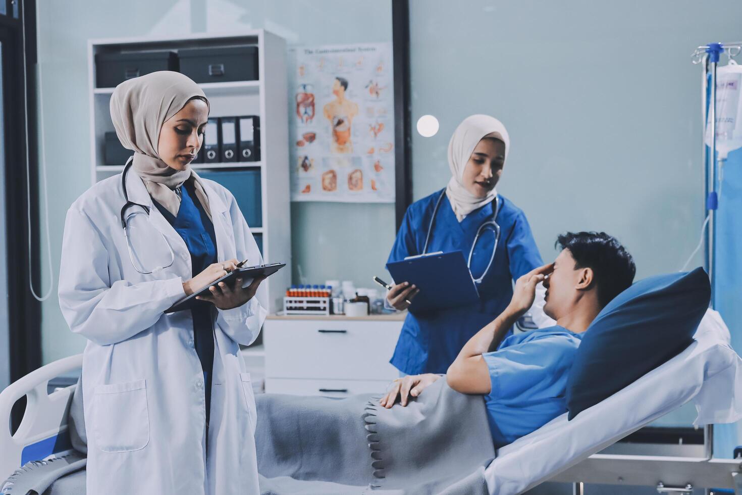 Asian muslim doctor talking to patient in hospital photo