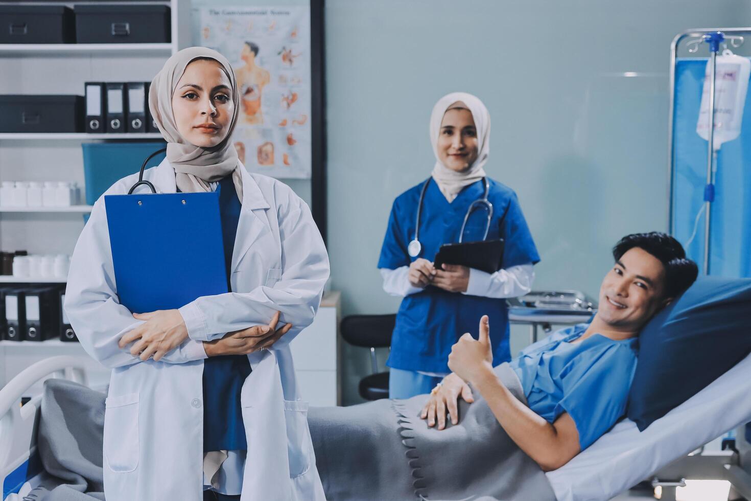 Asian muslim doctor with patient in hospital photo