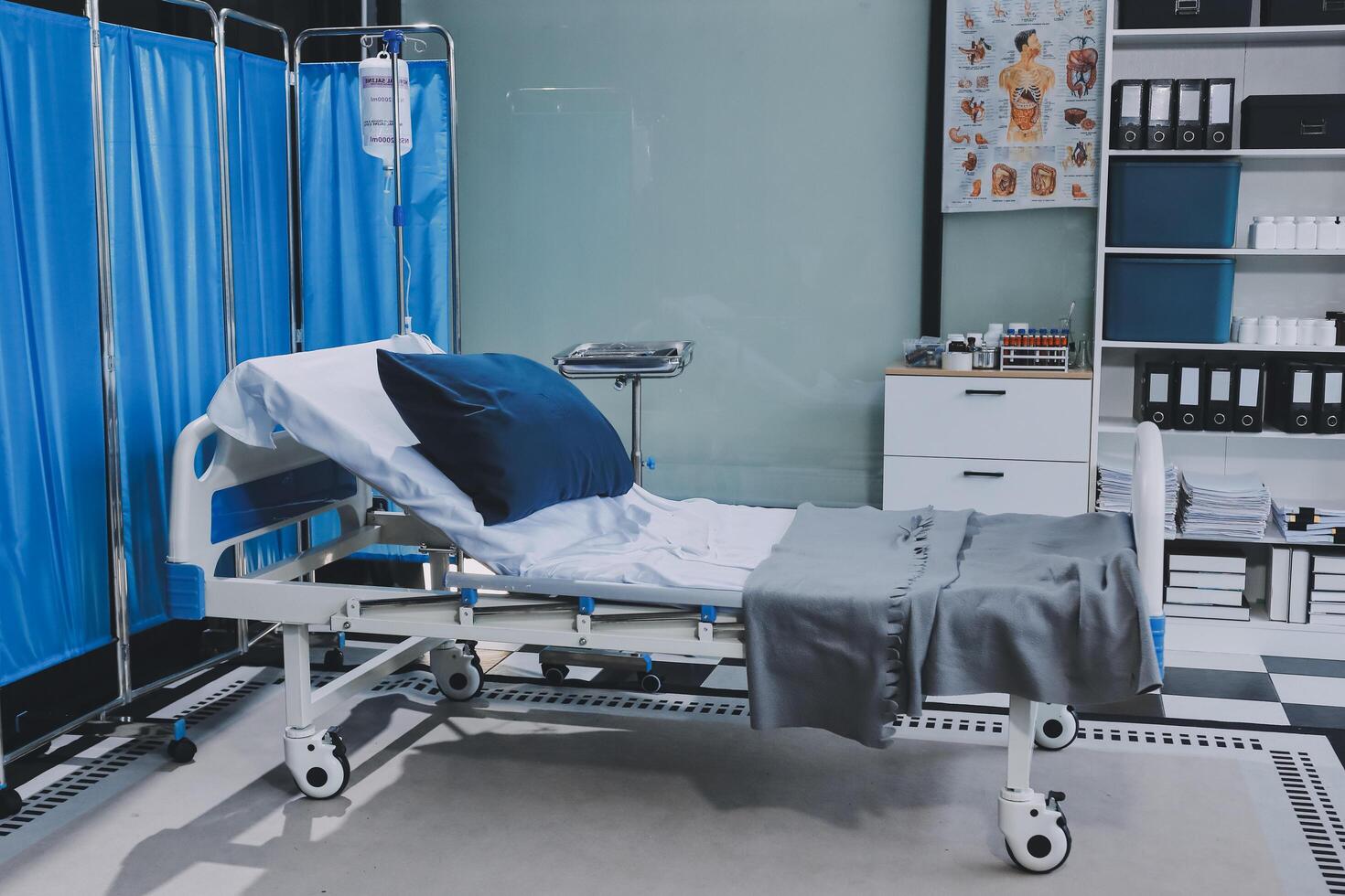 A hospital bed with blue curtains and pillows photo