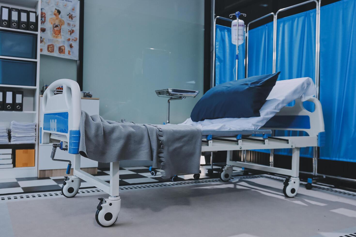 A hospital bed with blue curtains and a blue curtain photo