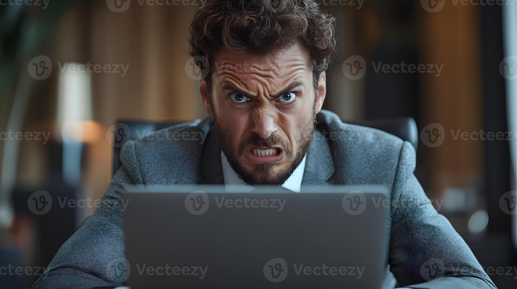 Frustrated professional frowning while reading an email on a laptop. photo