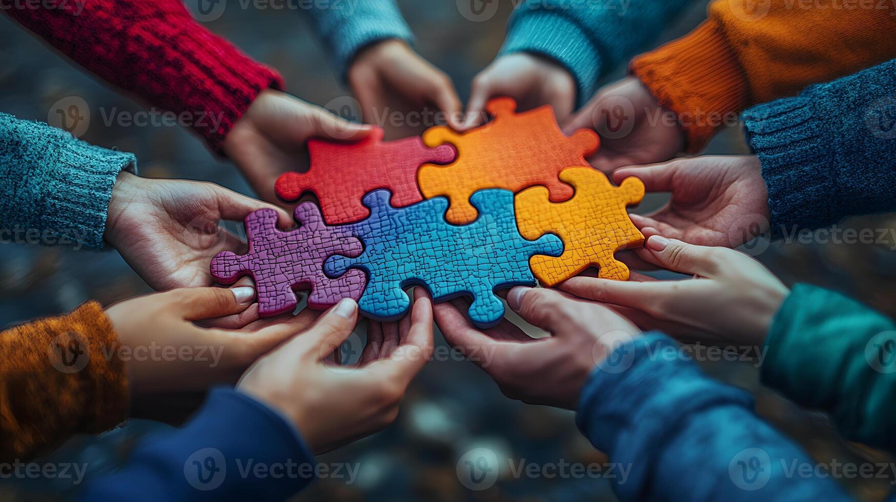Diverse group joining hands with puzzle patterns to show autism awareness unity photo