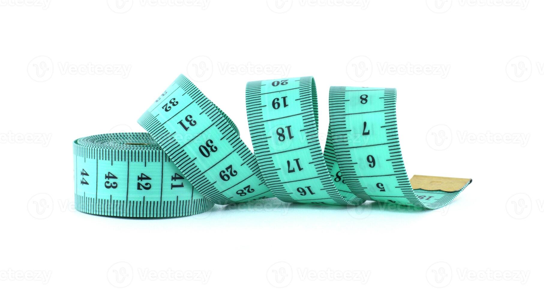 A light green measuring tape coiled on a white background, commonly used in sewing and tailoring. photo