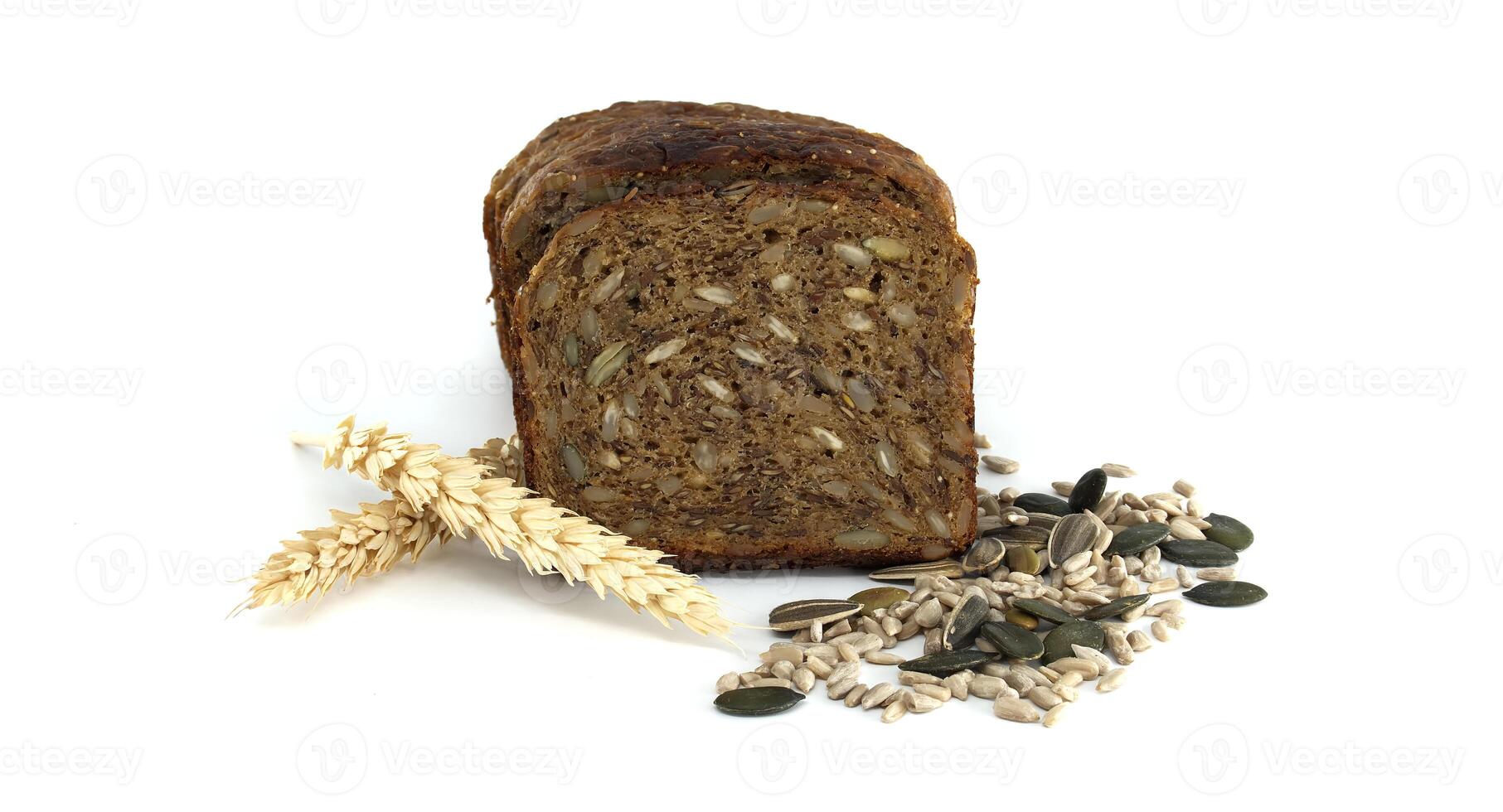 Slices of whole wheat seed bread presented with wheat and a mix of seeds, on white. photo