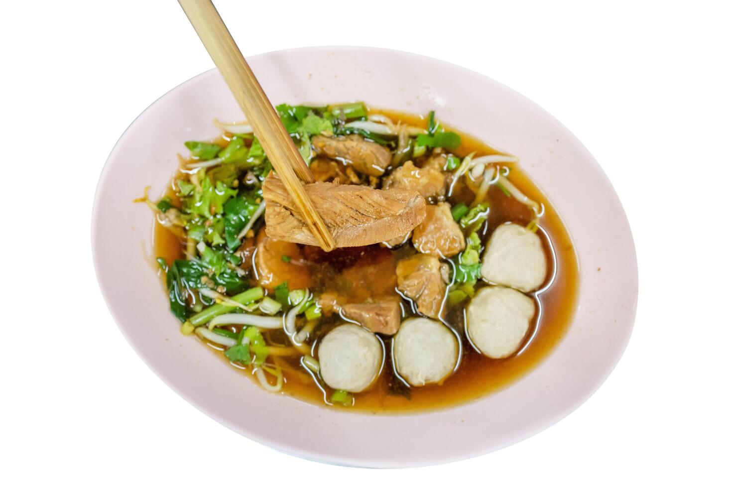 Chinese clear soup and Beef noodle and chopsticks, focus selective photo
