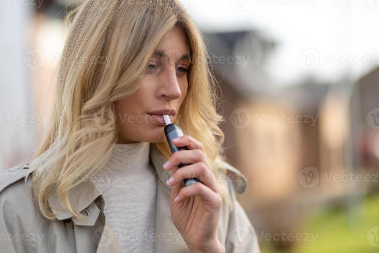 Woman enjoying a vaping experience outdoors in a suburban setting during the afternoon photo