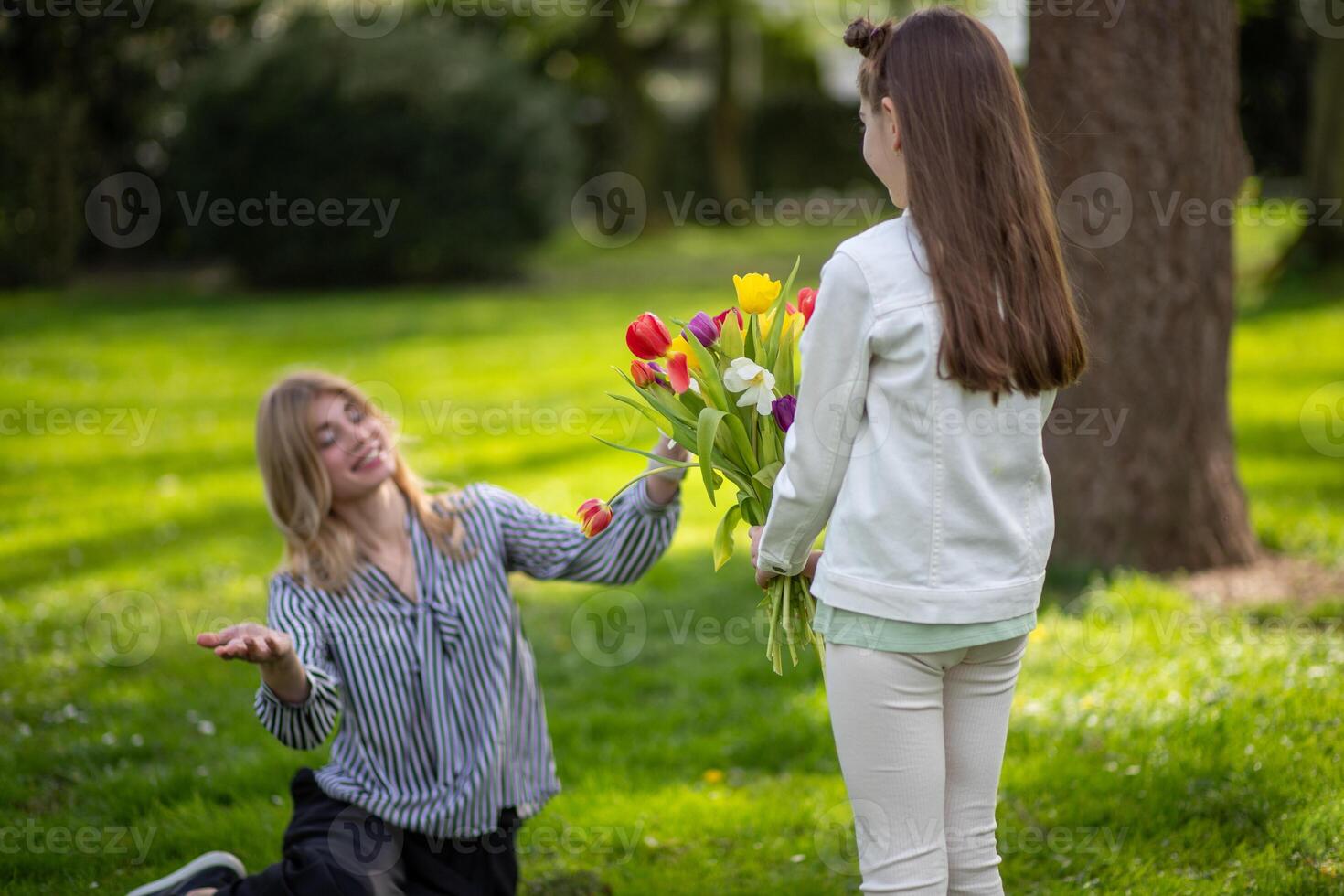 Daughter gifting mother tulips. Family celebration, love and appreciation. photo