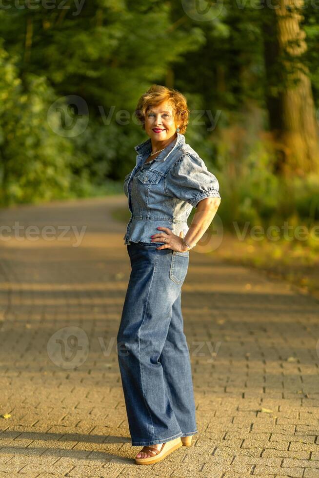 Woman posing confidently in a denim outfit while standing on a photo