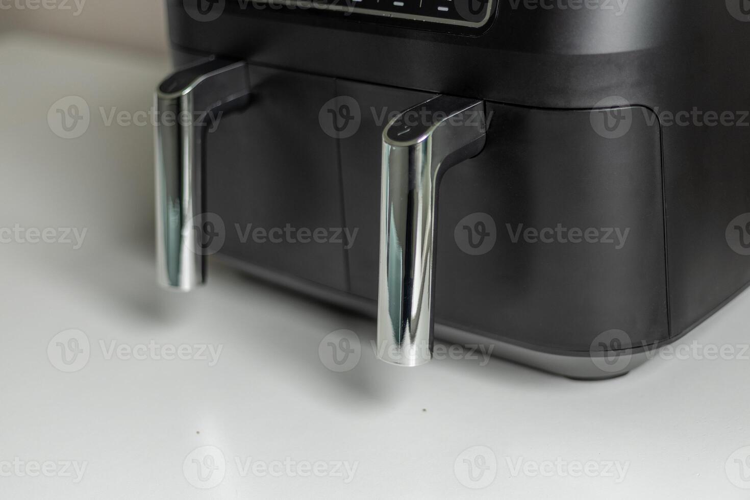 Black air fryer with metal handles photo