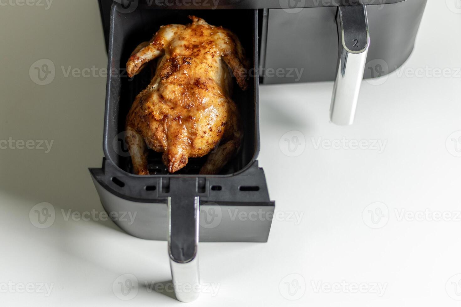 Roasted chicken in the air fryer basket photo