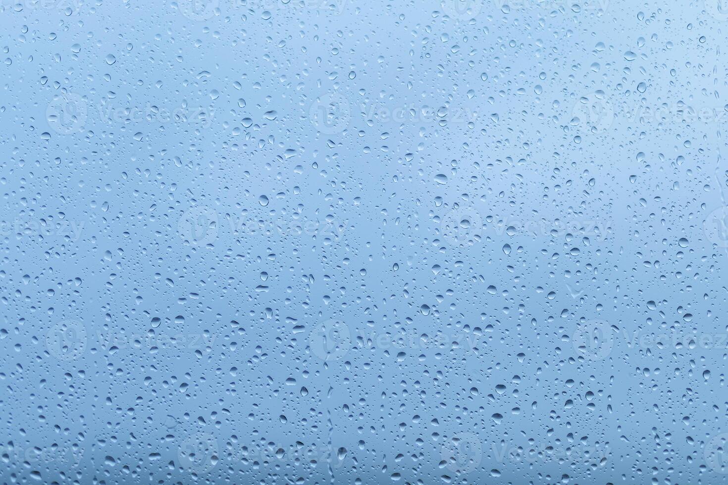 Rainfall creates a soothing atmosphere on a clear blue sky background, enhancing the calmness of the surroundings during a quiet afternoon photo