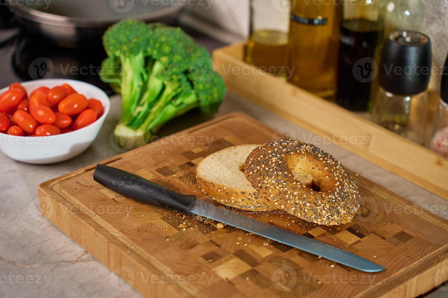 Preparing bagel sandwich with fresh ingredients in kitchen photo