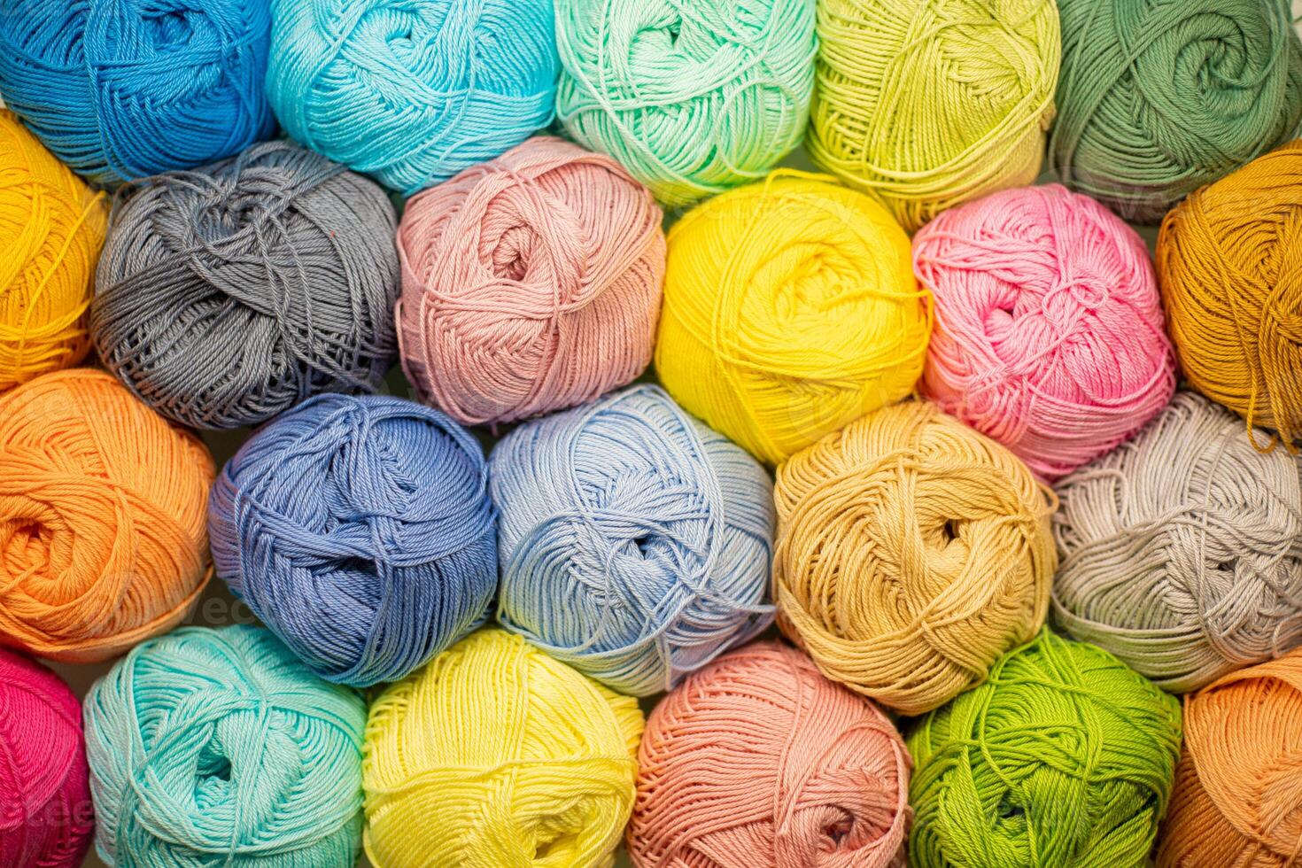 Background from colored yarn. Balls of thread close-up. Materials for needlework. Rack with yarn in the store. Shelf with multi-colored threads for knitting photo