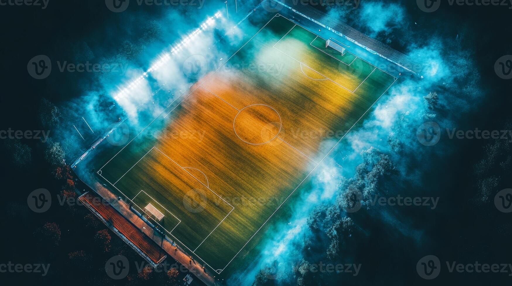Vibrant soccer field illuminated at night with colorful lighting and fog creating a dramatic atmosphere photo