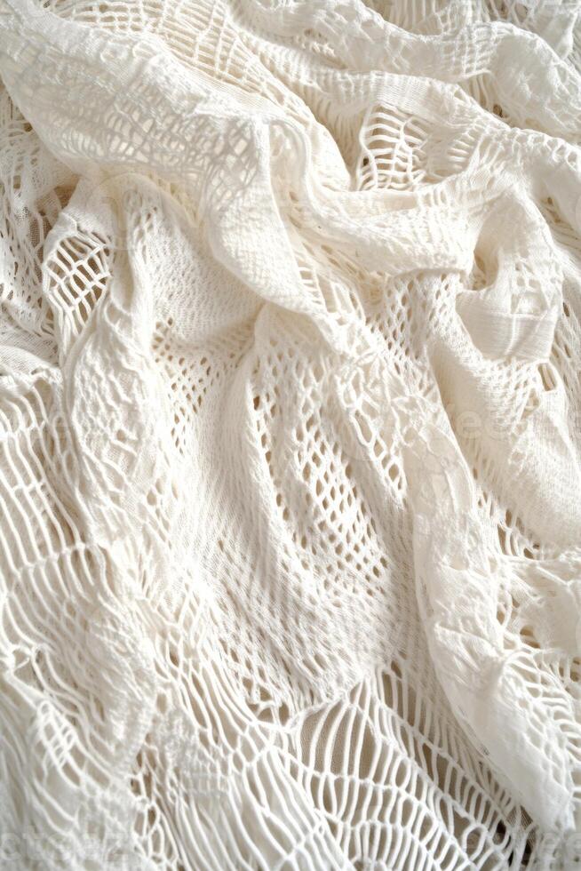 Elegant white lace fabric draping softly on a surface with intricate patterns and textures in natural light photo