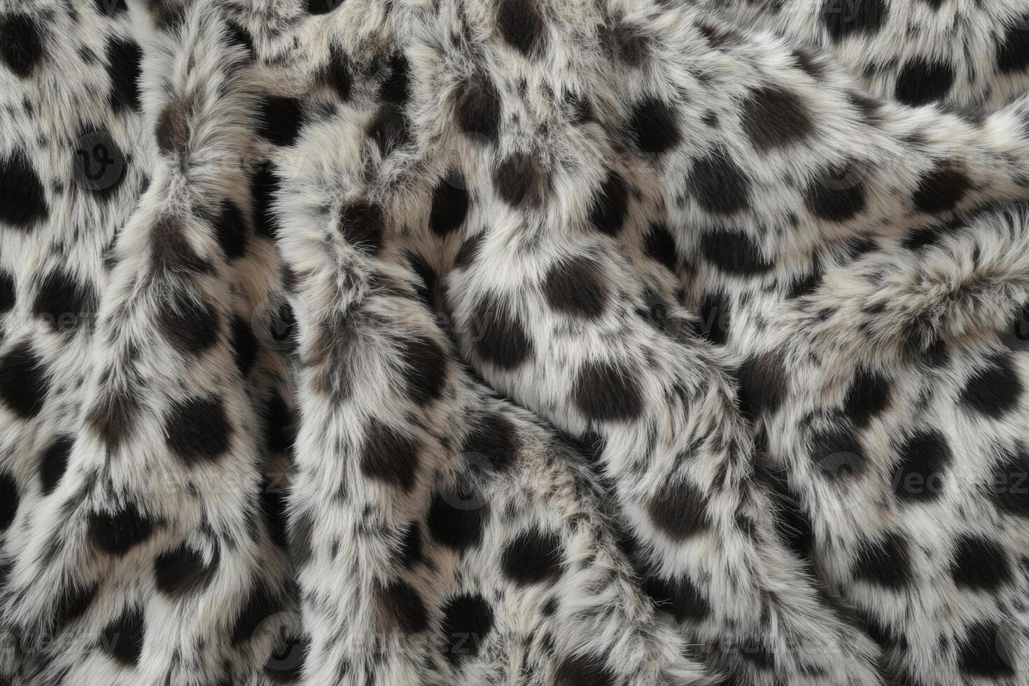 Soft and stylish faux fur fabric with black and white spots for cozy home decor photo