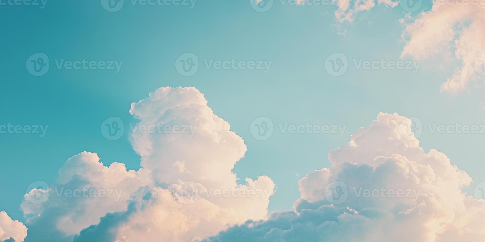 Clouds drift peacefully across a bright blue sky during a serene afternoon photo
