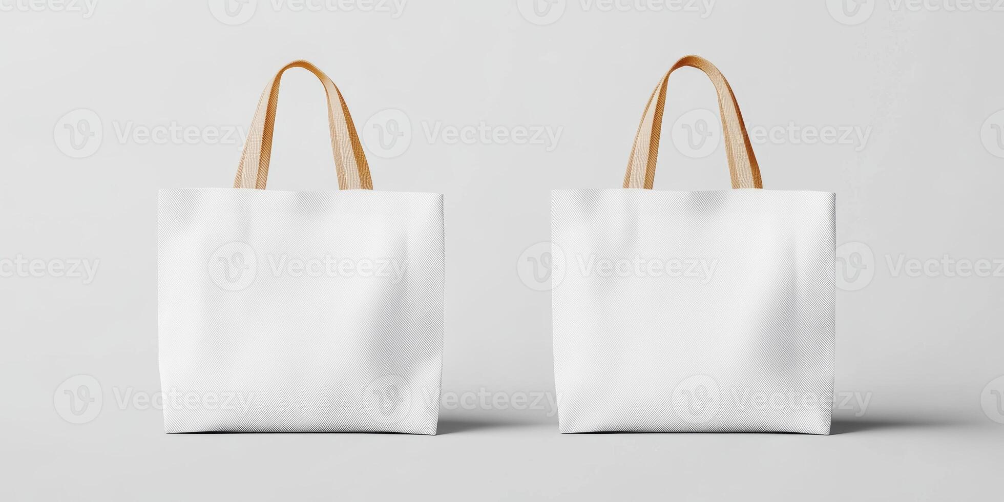 Two empty white tote bags with tan handles placed on a minimalistic gray background showcasing reusable storage options photo