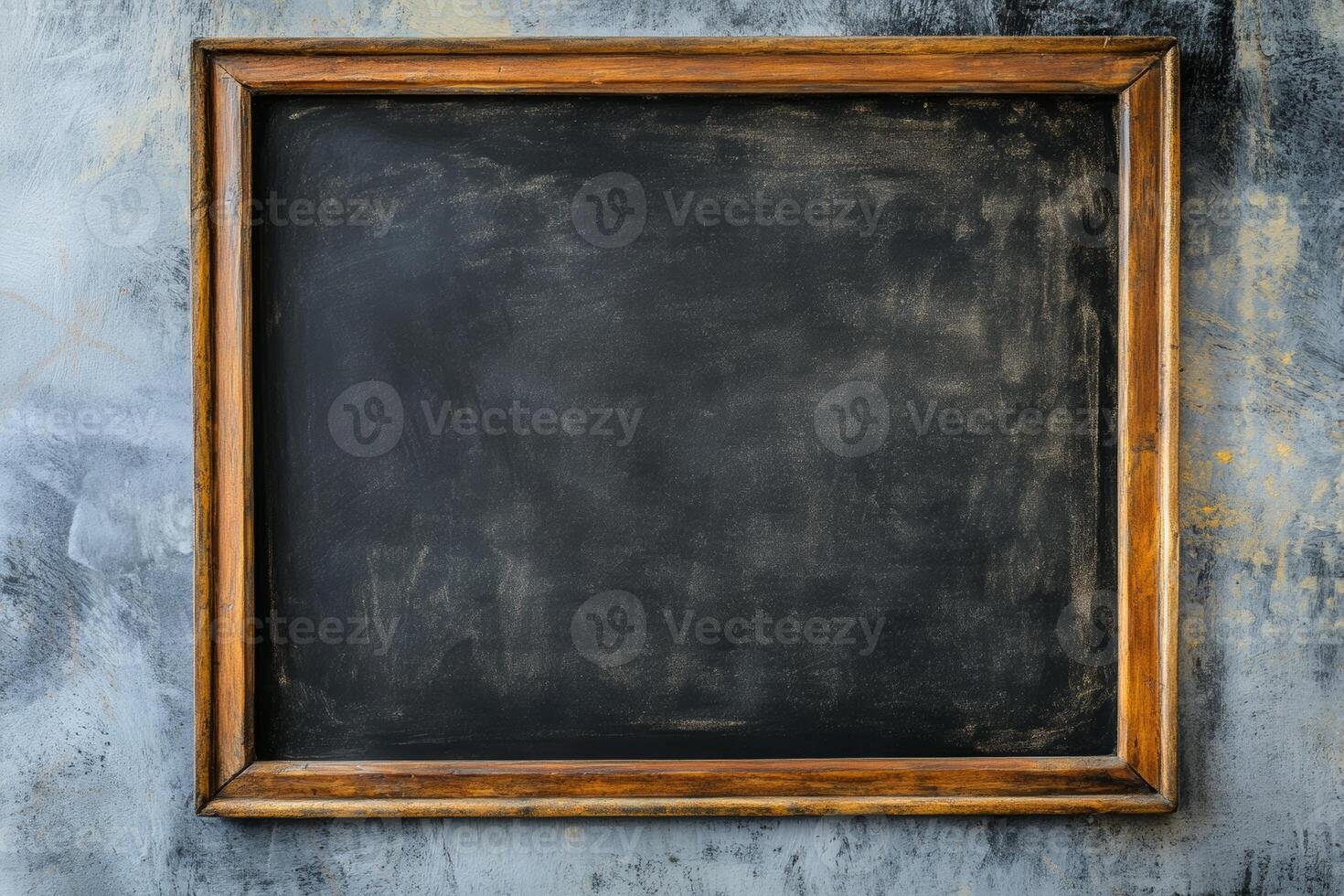Empty chalkboard framed in wood against a textured wall ready for new lessons or creative ideas photo