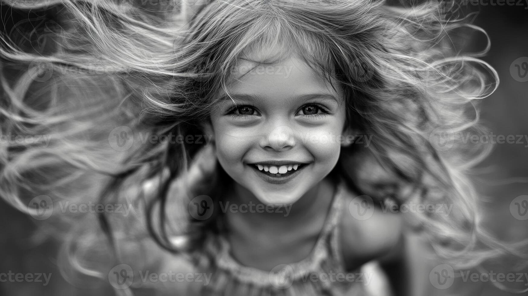 Joyful girl with flowing hair smiles brightly in a playful moment outdoors during summer photo