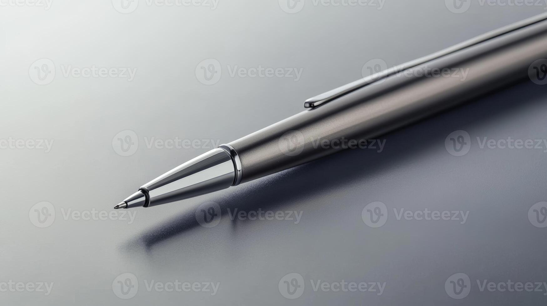 Elegant silver pen resting on a polished surface, capturing light in a minimalist setting photo