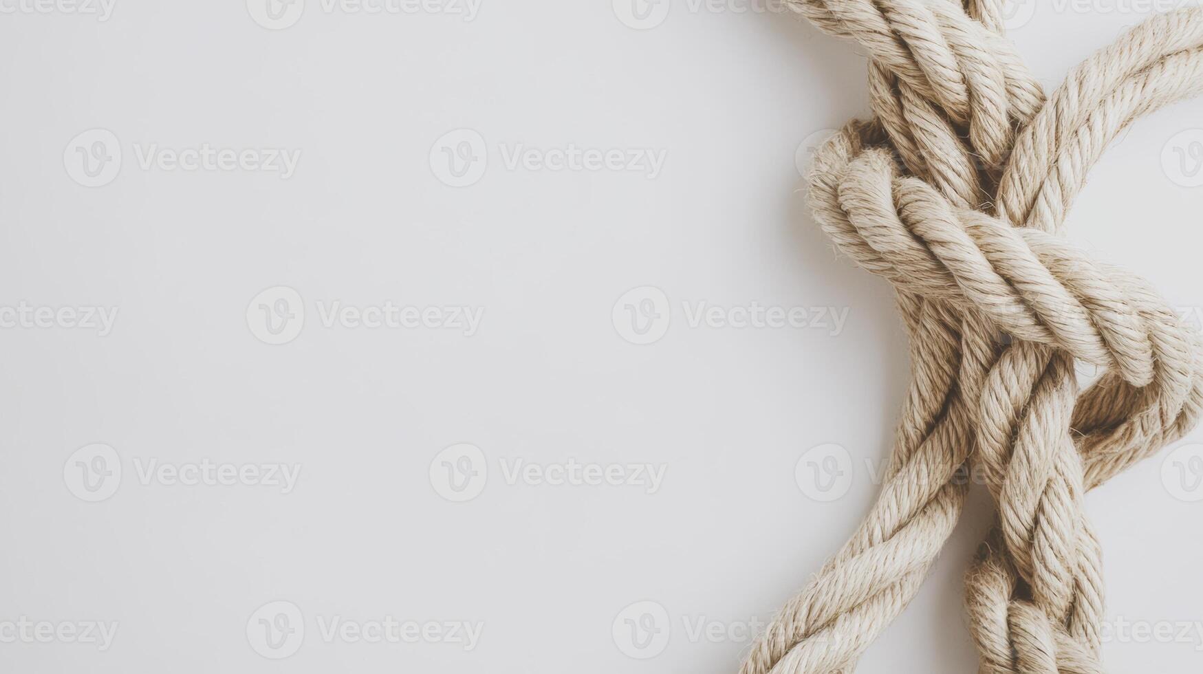 Twisted jute rope arranged in a loop on a clean white background for crafting and decorative purposes photo