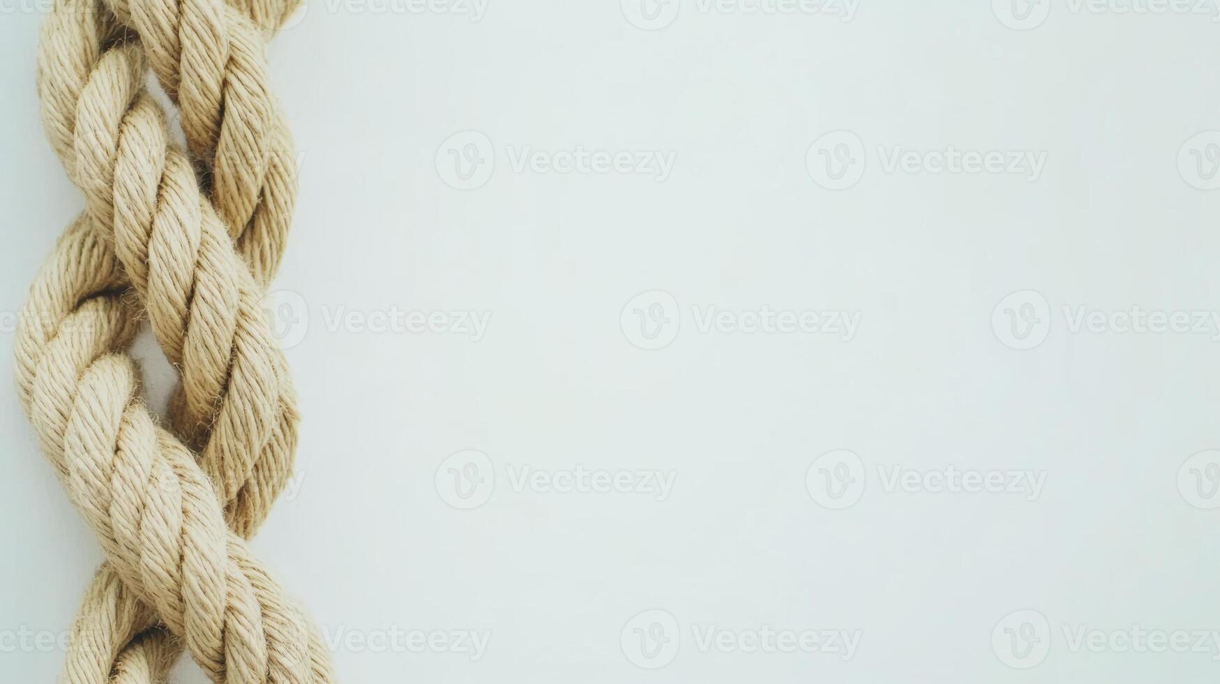 Twisted jute rope laid against a smooth white background creating a minimalistic and natural aesthetic photo