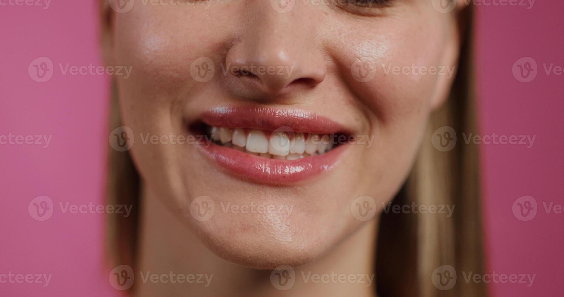 A close up of a woman smiling with her teeth photo