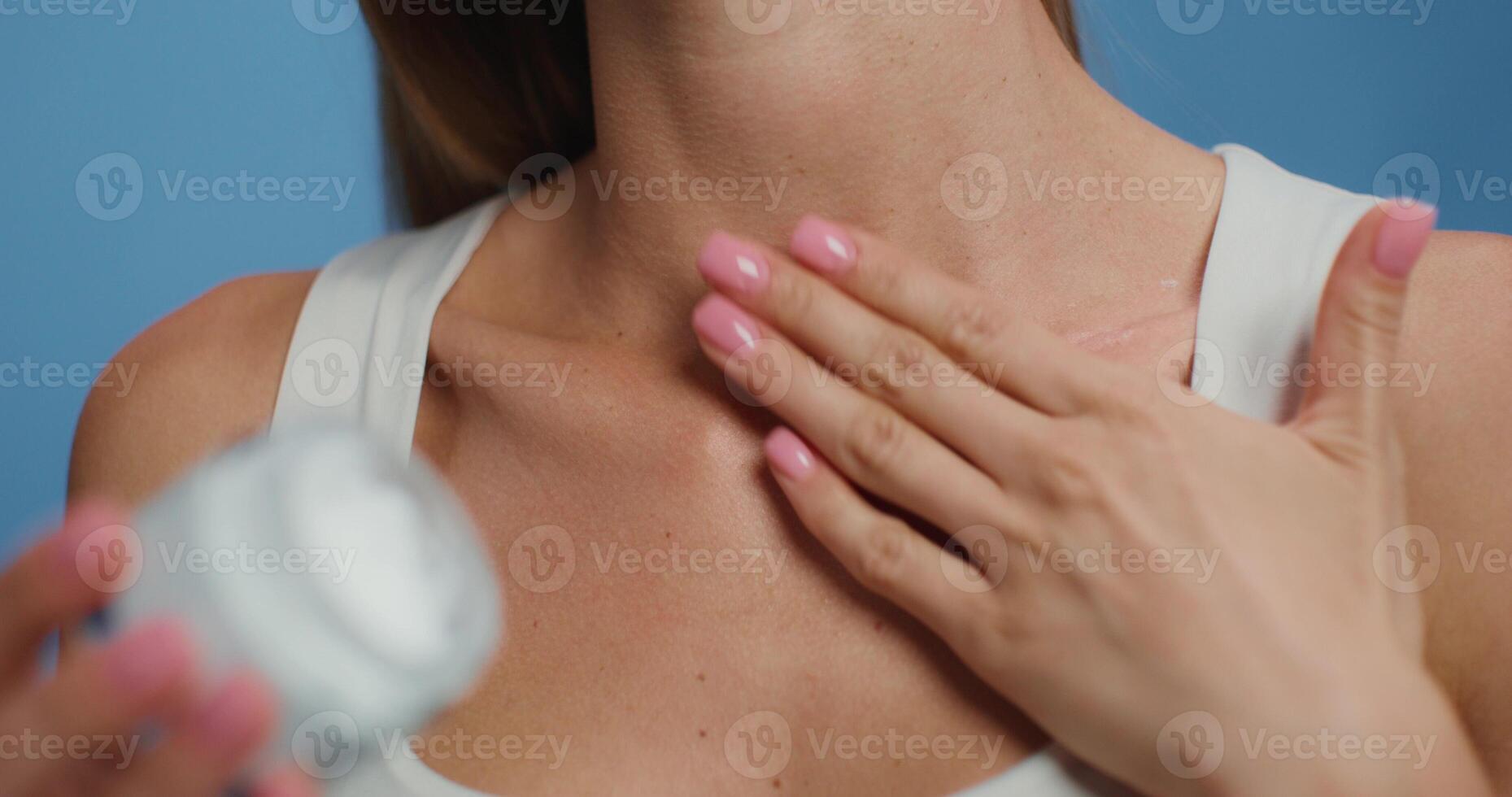 A woman is using a cream to treat her skin photo