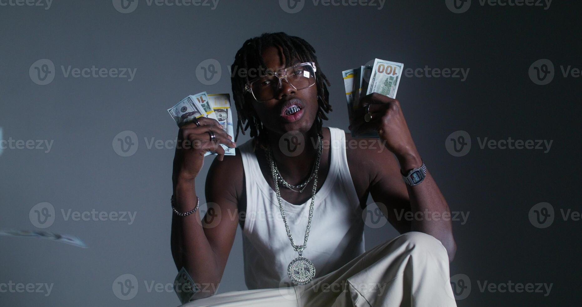 A man is holding up money in front of him photo