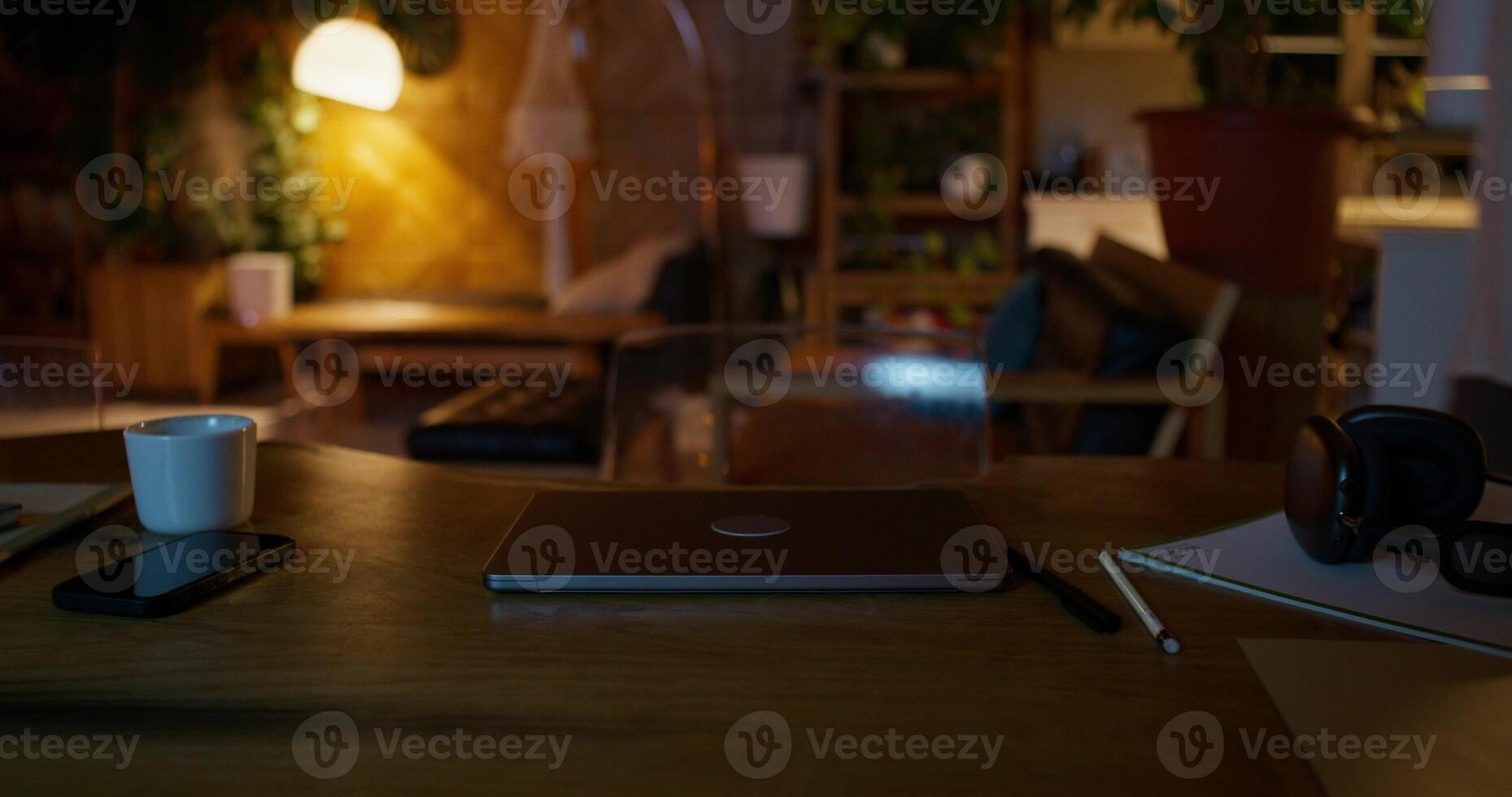 A laptop on a desk with a cup of coffee and a phone photo