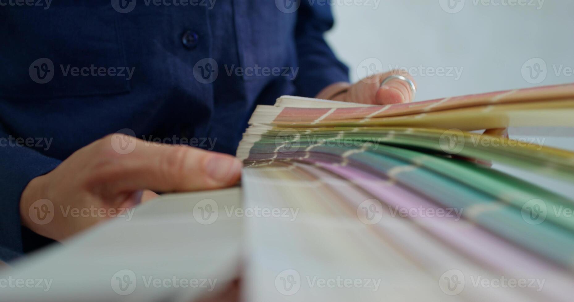 A person holding a sample of paint samples photo