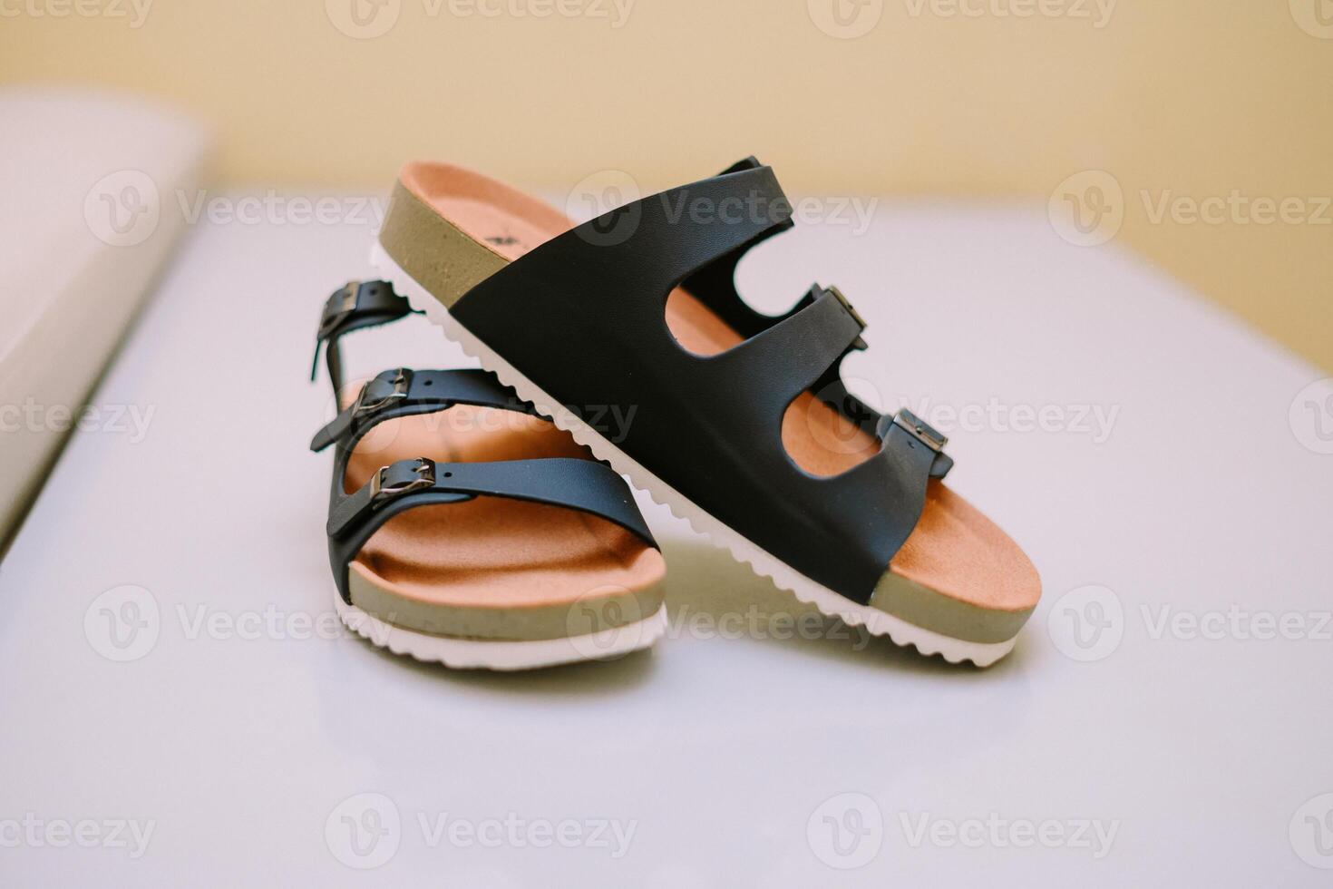 Summer essentials two stylish black buckle sandals on a clean surface photo